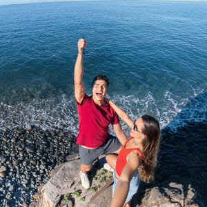 Group filming perspective beside an open coastal viewpoint
