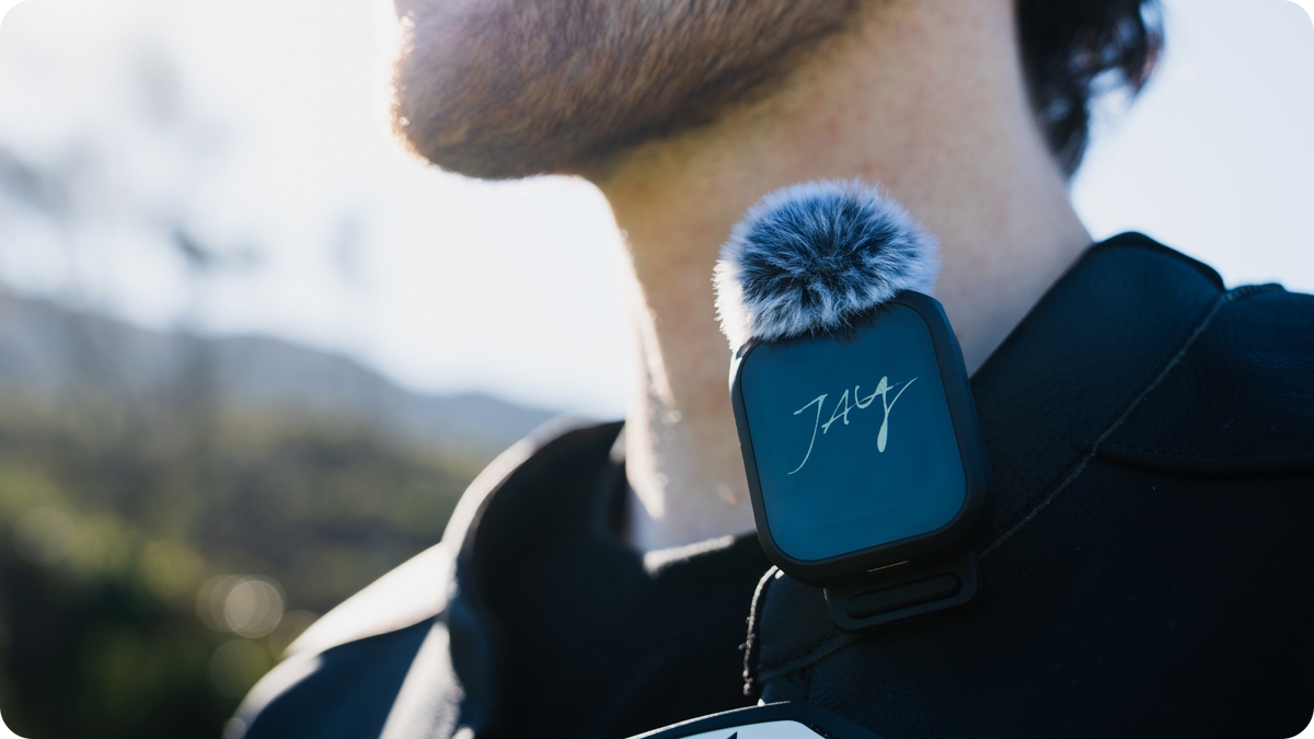 Insta360 GPS Preview Remote with Built-In Mic microphone clipped to a collar