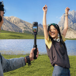 Travel filming setup with a separate 360 camera and selfie stick