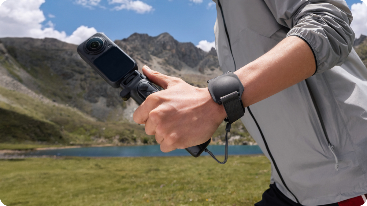 Insta360 Foldable Selfie Stick Remote Kit Extended Edition Lens Cap Strap used as a wrist strap during filming, camera sold separately